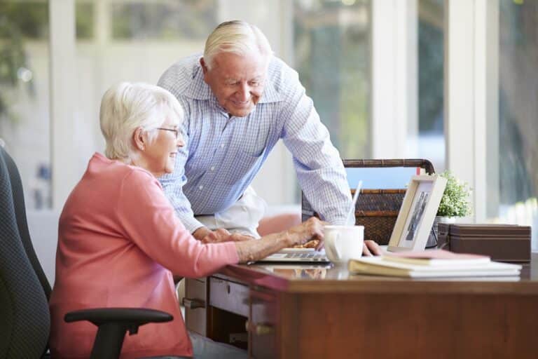 Happy senior couple using a laptop