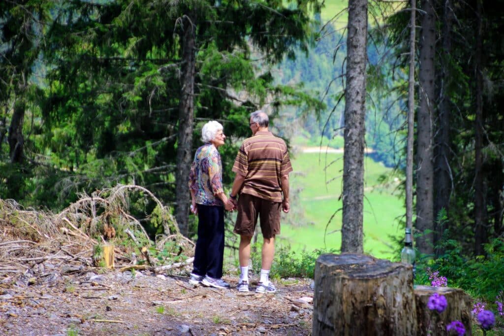 Couple in a wooded area holding hands