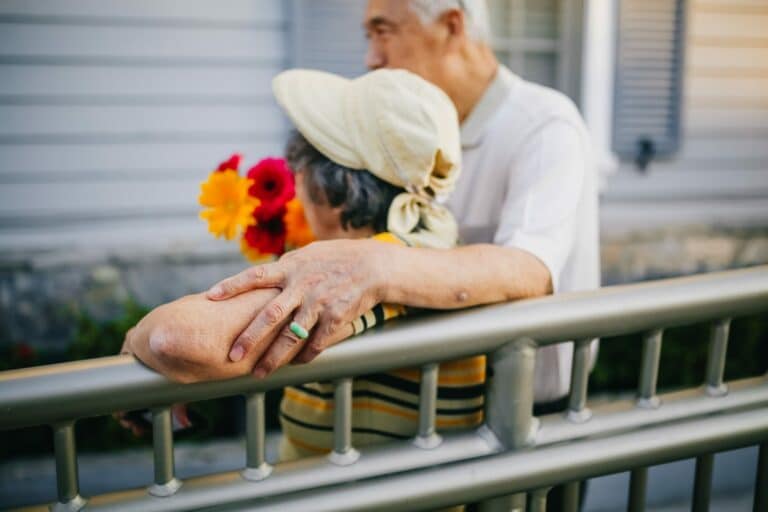 Older couple out side with flowers