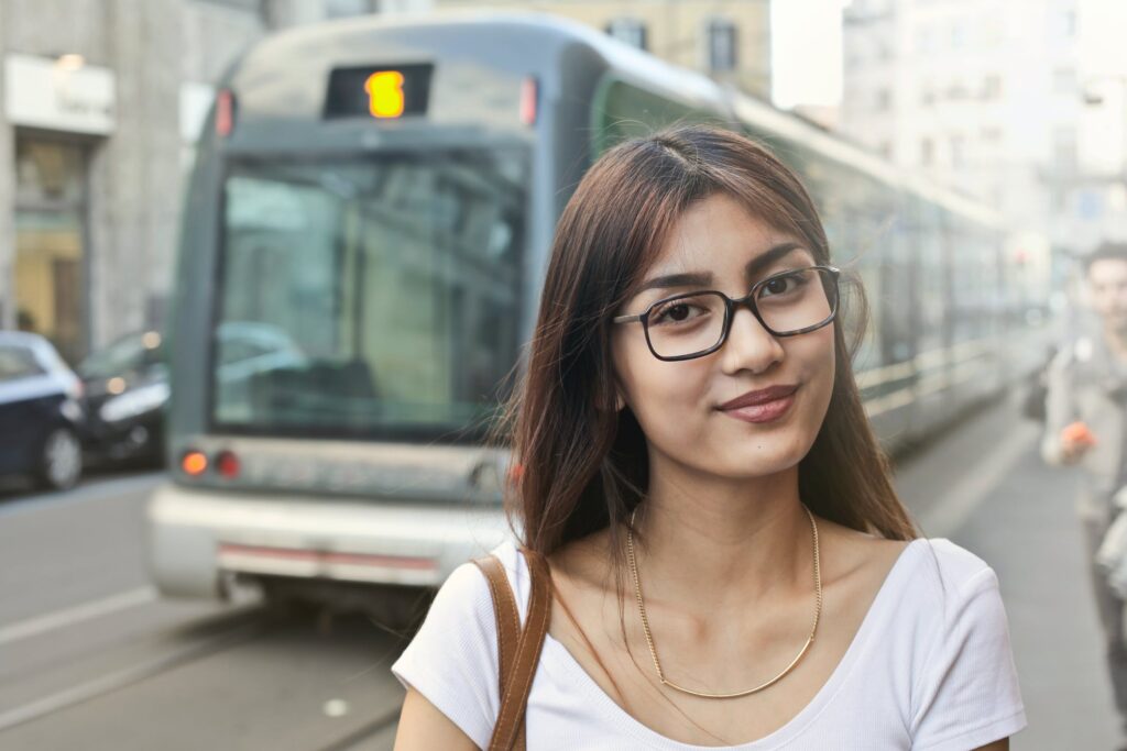 Woman outside with commuter city train in the background