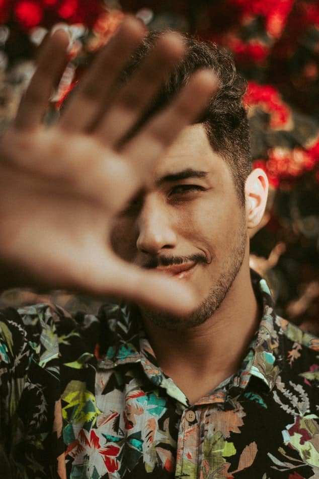 Man with hand held out in front of camera