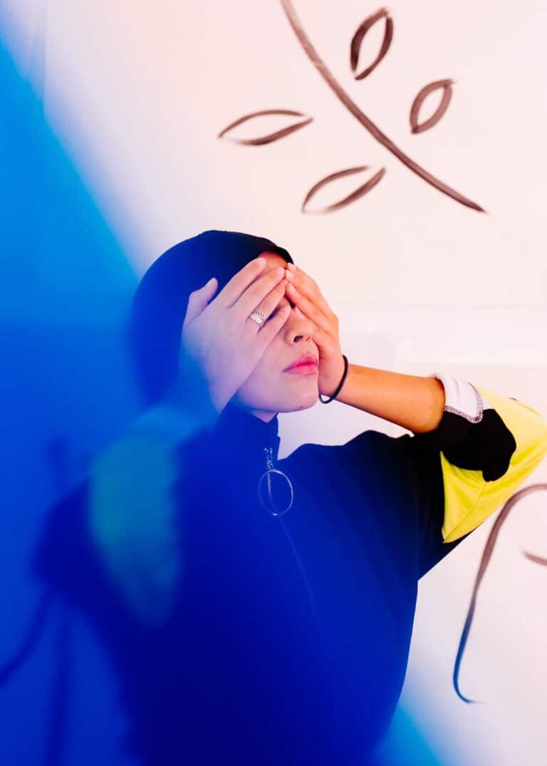 Woman with hands over her eyes