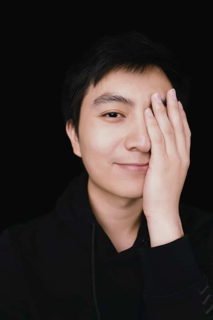 Person with a hand over an eye